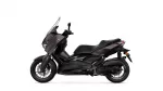 Side view of a black Yamaha XMAX motorcycle with a tall windshield on a white background, showing front wheel and body panels.