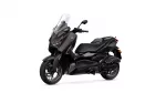 Yamaha X-MAX scooter in dark brown/black with a tall clear windshield, shown from a front-left angle.