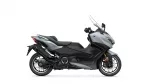 Side view of a gray Yamaha sport scooter with a tall clear windscreen and black seat