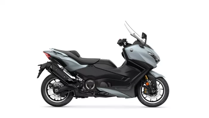 Side view of a gray Yamaha sport scooter with a tall clear windscreen and black seat
