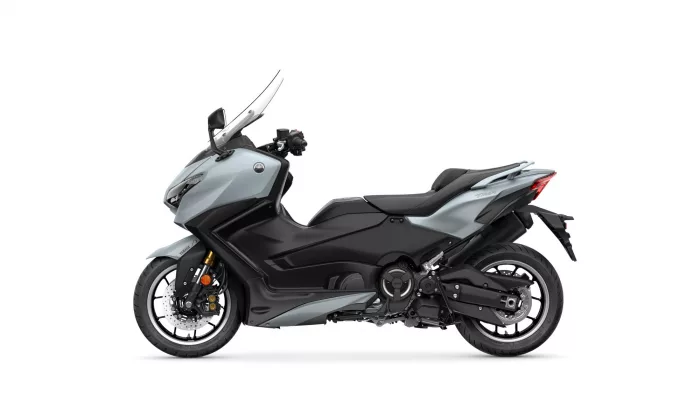 Side view of a silver-gray Yamaha sport motorcycle showcasing its sleek body, windshield, and exposed engine components on a white background