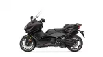Side view of a black Yamaha TMAX sport scooter with windshield and prominent front fairing