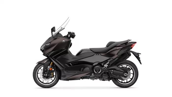 Side view of a black Yamaha TMAX sport scooter with windshield and prominent front fairing