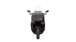 Front view of a dark sport motorcycle with a tall windshield and angular headlights, facing forward.