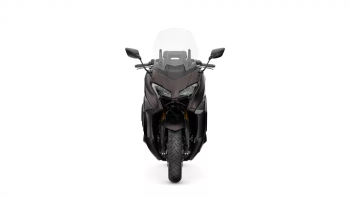 Front view of a dark sport motorcycle with a tall windshield and angular headlights, facing forward.