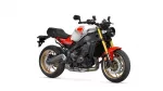 Front three-quarter view of a Yamaha XSR900 motorcycle with red and white bodywork, gold inverted front forks, and exposed engine.