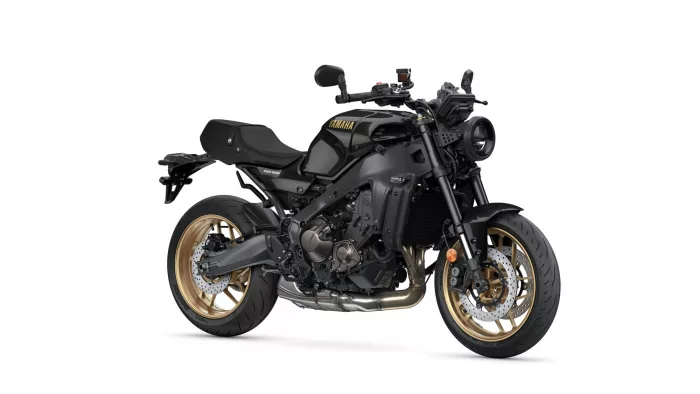 Black Yamaha sport motorcycle with gold wheels, angled left-side view showing engine and exhaust