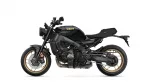 Black Yamaha motorcycle seen in profile, showing gold-rimmed wheels and sleek matte-black bodywork with 'YAMAHA' on tank (XSR900).
