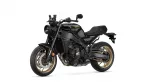 Black Yamaha XSR900 motorcycle shown from the front-left side with a matte black body and gold wheels.