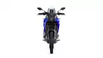 Front view of a blue adventure motorcycle with a windshield and rugged tires facing the camera.