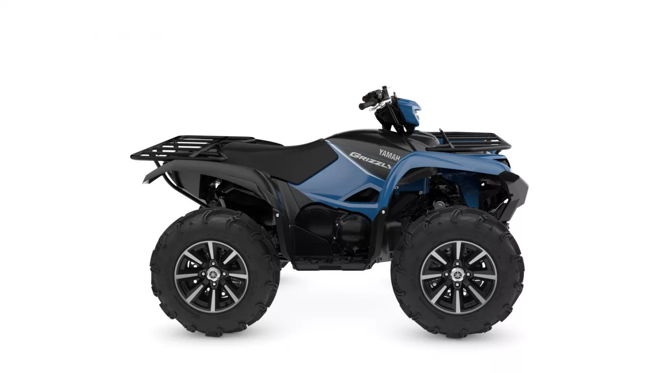 Blue and black Yamaha Grizzly all-terrain vehicle (ATV) with large off-road tires and front rack, side view