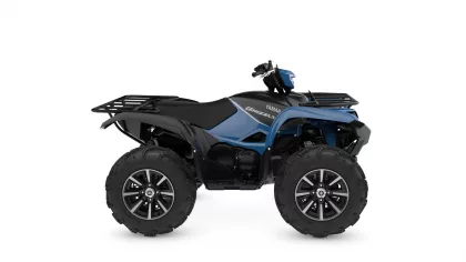 Blue and black Yamaha Grizzly all-terrain vehicle (ATV) with large off-road tires and front rack, side view