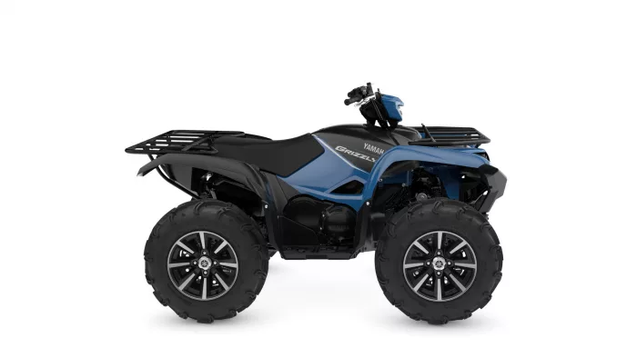 Blue and black Yamaha Grizzly all-terrain vehicle (ATV) with large off-road tires and front rack, side view