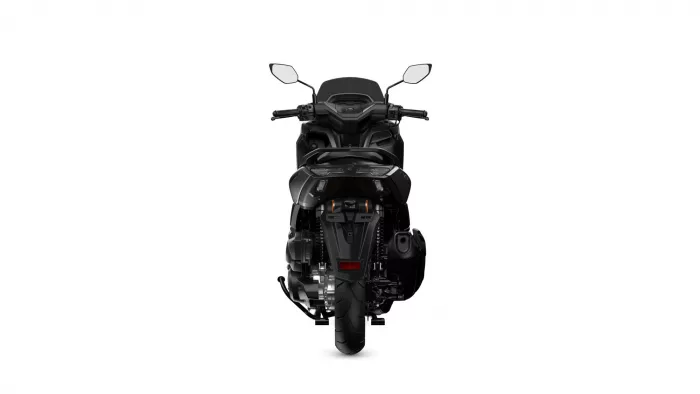 Rear view of a black sport motorcycle against a white background, showing taillight area and dual exhausts partly visible at the sides.