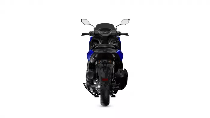 Rear view of a blue sport motorcycle, showing the taillight, seat, and wide rear tire centered against a white background.