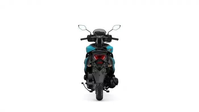 Rear view of a teal and black motorcycle with two mirrors and a red taillight assembly under a white background