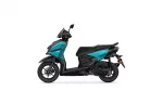 Side view of a teal and black Yamaha scooter photographed from the left.