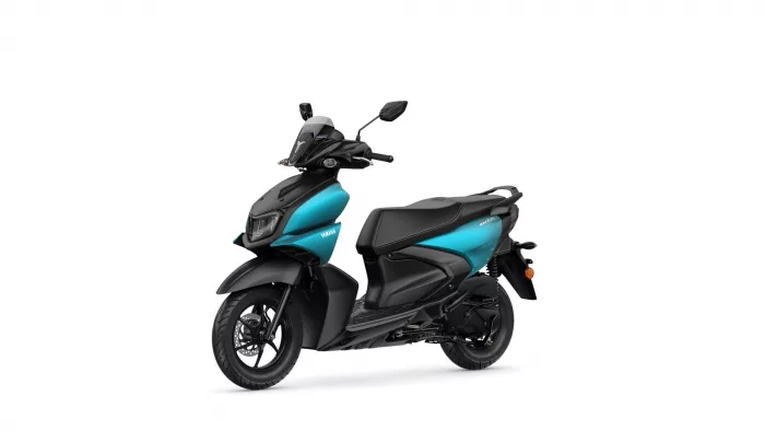 Two-tone teal and black Yamaha scooter shown from a front-left angle, highlighting its aerodynamic body and wheels, with 'YAMAHA' logo visible on the side panel.