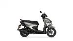 Silver and black Yamaha scooter photographed from the side, showing the seat, body panels, and front wheel with disc brake