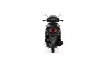 Rear view of a black motorcycle showing the seat, mirrors, and taillight area.