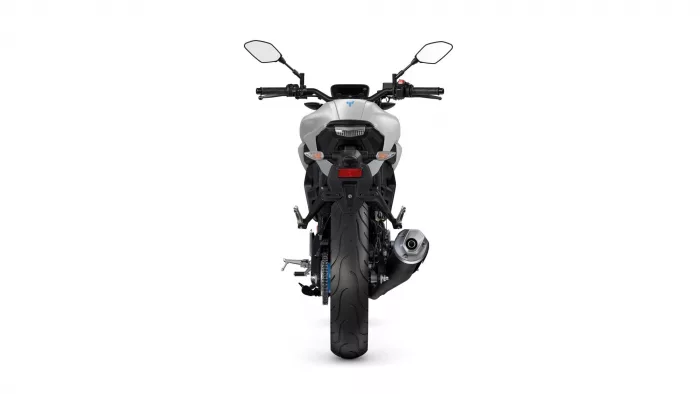Rear view of a white sport motorcycle, showing taillight, exhaust, and rear wheel from behind