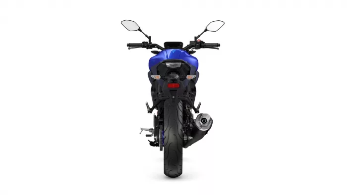 Blue sport motorcycle seen from the rear, showing taillights, exhaust, and rear tire.