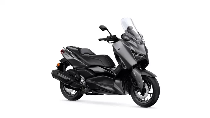 Dark gray Yamaha maxi-scooter with a tall clear windshield and visible front disc brakes.