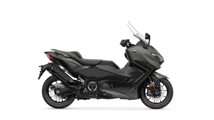 Side view of a Yamaha sport motorcycle with a tall clear windshield on a white background.