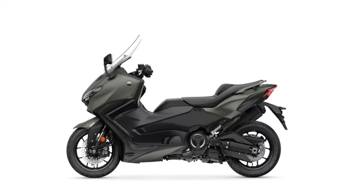 Side view of a dark gray Yamaha sport motorcycle with a windshield and exposed engine components against a white background.