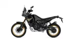 Side view of a black Yamaha Tenere 700 World Raid off-road motorcycle with gold rims and rugged windscreen