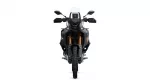 Front view of a black adventure motorcycle with a tall white windshield, dual headlights, and gold front forks viewed head-on.