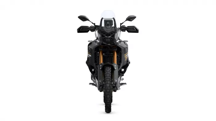 Front view of a black adventure motorcycle with a tall white windshield, dual headlights, and gold front forks viewed head-on.