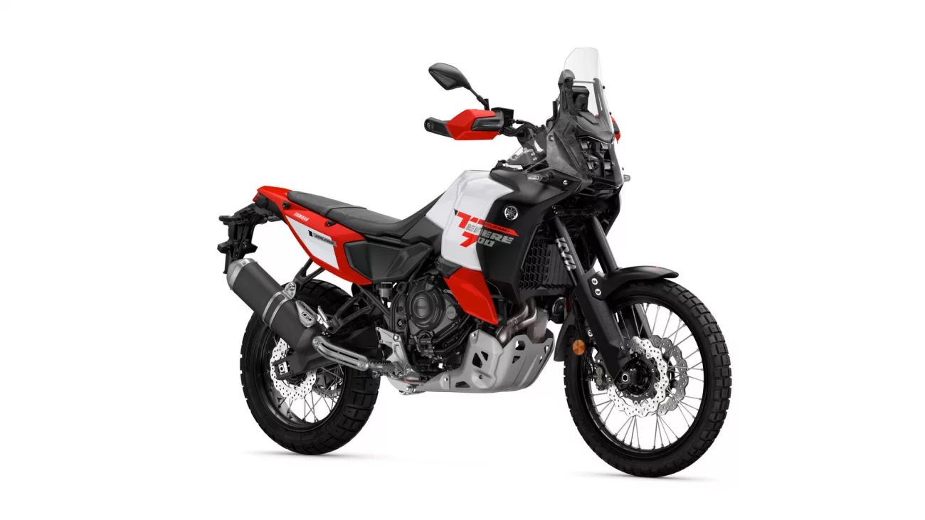 Side view of a red, white, and black Yamaha adventure motorcycle with a tall windscreen and off-road tires on a white background.