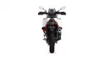 Rear view of a white adventure motorcycle with red accents, tall windscreen, and off-road tires seen from the back.