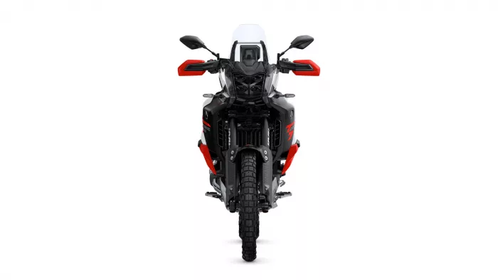 Front view of a black-and-red adventure motorcycle with a tall windshield and rugged tires, facing the viewer from the center.