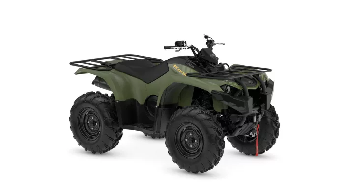 Green Yamaha Kodiak ATV with large knobby tires and front/rear cargo racks【0】.