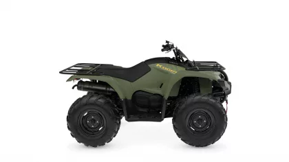 Green Yamaha Kodiak all-terrain vehicle (ATV) shown in side profile with front and rear cargo racks and chunky off-road tires