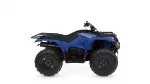 Blue Yamaha Kodiak ATV with large knobby tires and front/rear cargo racks.
