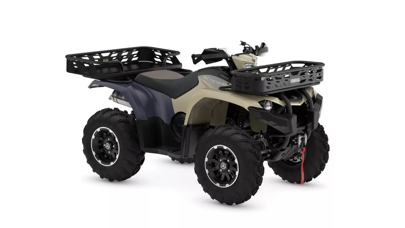 All-terrain vehicle (ATV) with front and rear cargo racks, beige and blue body, large off-road tires, shown from a side angle to highlight storage options.