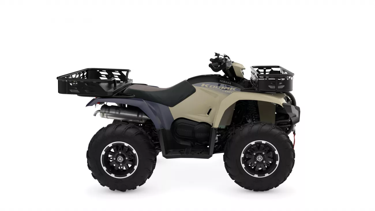Yamaha Kodiak ATV with beige body, black seat, and front and rear cargo racks.