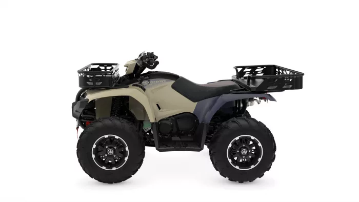 Beige all-terrain vehicle (ATV) with front and rear cargo racks and oversized knobby tires.