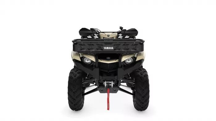 Front view of a beige Yamaha ATV with a black grille and large tires, showing a red tow strap under the bumper.