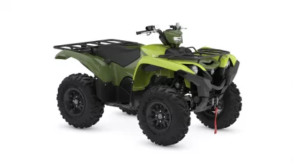 Green all-terrain vehicle (ATV) with large knobby tires and front cargo rack, shown on a white background.