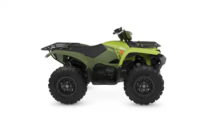 Green Yamaha ATV with large knobby tires and front/rear cargo racks, shown in side profile.