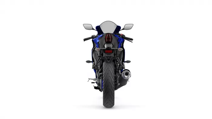 Rear view of a blue sport motorcycle showing taillight, mirrors, and exhaust against a white background.