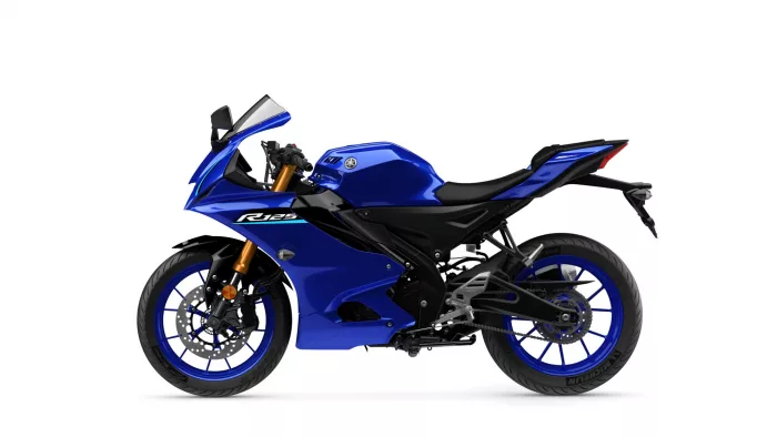 Blue Yamaha R125 sport motorcycle shown from the side, highlighting its fairing, fuel tank, and blue wheels on a white background, isolated image