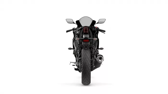 Rear view of a black sport motorcycle with red tail light and silver exhaust against a white background.
