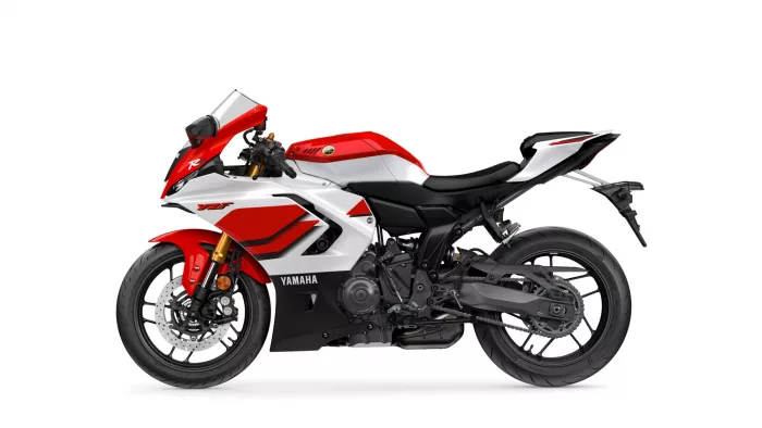 Red-and-white Yamaha sport motorcycle shown in profile from the left, with a visible front disc brake and wheel edge on white background.