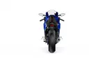 Rear view of a blue sport motorcycle showing taillight, rear wheel, and exhaust, centered against a white background.
