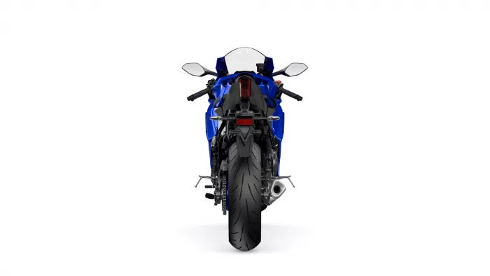Rear view of a blue sport motorcycle showing taillight, rear wheel, and exhaust, centered against a white background.